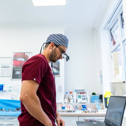 Dr George Karageorgiou in surgical loupes beside the planning laptop